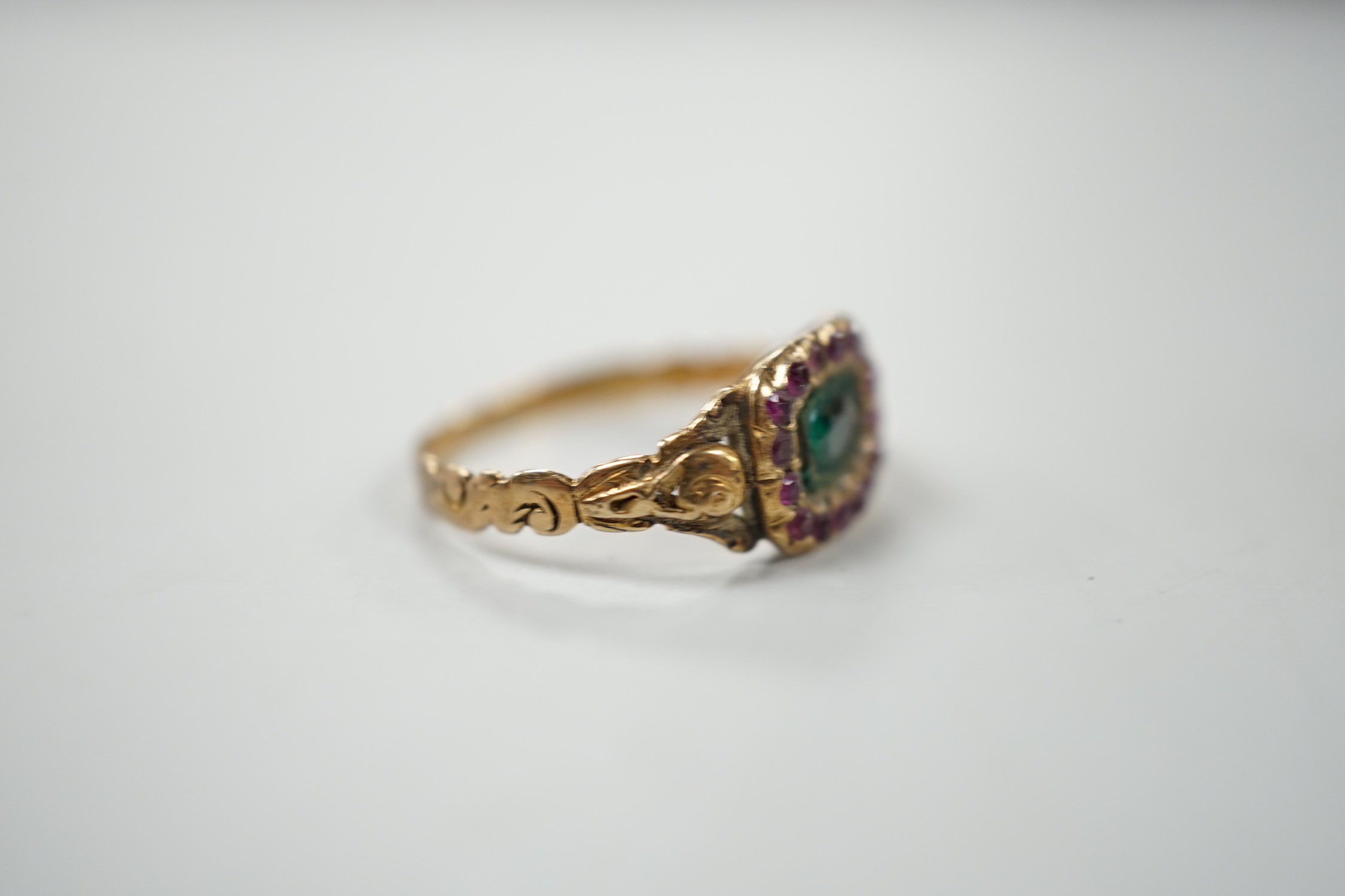 A 19th century yellow metal and two colour garnet? cluster set dress ring, size J, gross weight 1.6 grams.